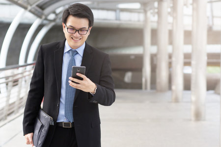 close up of Young Man using phone or Business man Contact Customerの写真素材