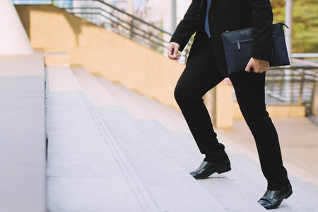 businessman legs walking the stairs in modern city.の写真素材