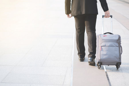 Businessmen are traveling With luggage on Contact business.の写真素材