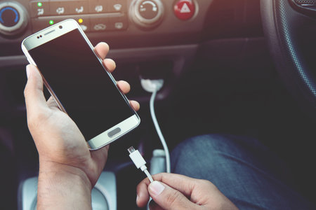 Power plug charging phone in car.の写真素材