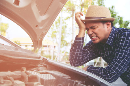 young stressed man having trouble with his Stress broken car Engine room crash at failed engine Wait for help.の写真素材