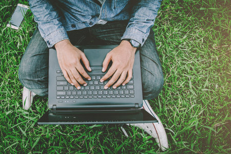 Connect online business using laptop. or Sitting work on the parks.の写真素材