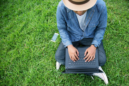 Connect online business using laptop. or Sitting work on the parks.の写真素材