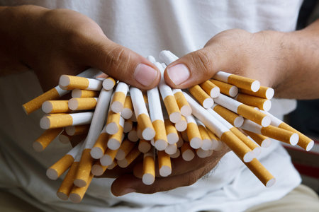 Stack Tobacco Cigarettes holding in hand.concept background Cigaretteの写真素材