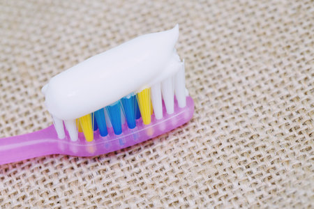 Toothbrush with toothpaste on a sackcloth backgroundの写真素材
