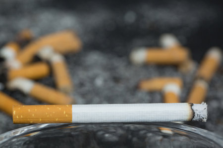 smoking Cigarette, pile tobacco cigarettes disrupted background .の写真素材