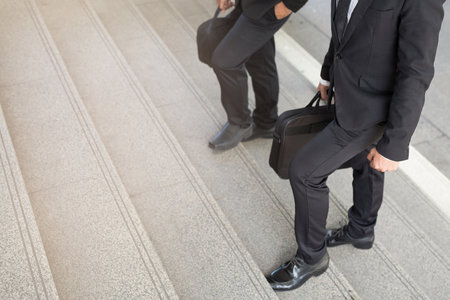 Businessman two people walking upstairs ,Fighting against obstacles Climb up to Successful finish we...