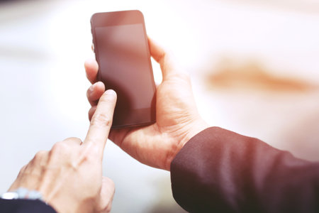 businessman using phone adult working on a digital. Check stock exchangeの写真素材