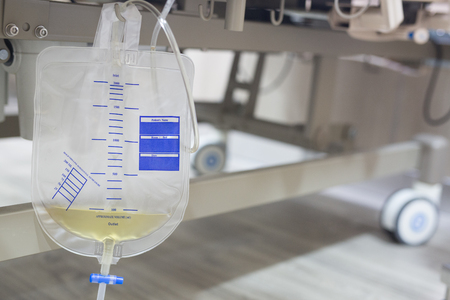 Iv saline bag infusion set and bottle on a pole. fluid intravenous drop saline drip slow hospital room or clinic. medical concept,treatment emergency shock. injection drug infusion care chemotherapyの写真素材