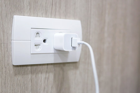 plugging adapter charge the battery with outlet socket plug and hold mobile phone on wall ,electric...