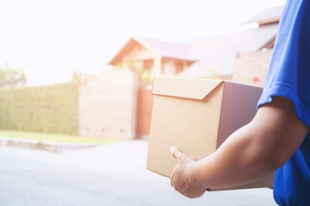 parcel delivery man happy hand thumb up in postal delivery courier in delivering package. Impressive service.の写真素材