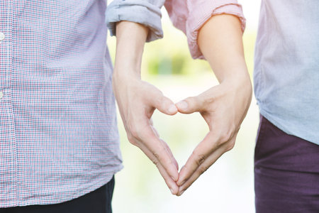 Happy gay Homosexual man Young couple lover show holding hands make supporting hands make heart...