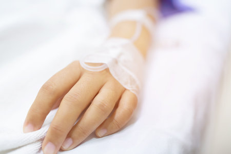 close up people focus on the hand of a patient sick on the bed in hospital ward. healthcare and medicalの写真素材