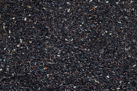 close up integral uncooked heap of raw jasmine brown rice scattered out texture. top viewの写真素材