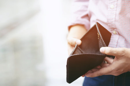 Empty wallet (no money) in the hands of an man. Cost control expenses poverty in conceptの写真素材