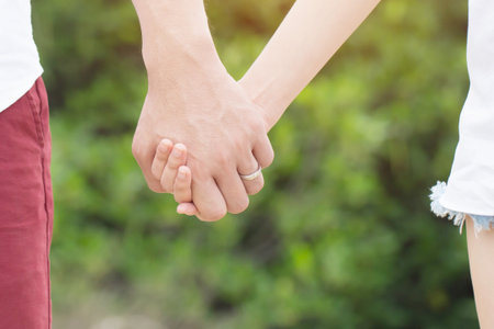 Woman and man holding hands shake, Happy couple love. concept couple lover valentine day. show ring weddingの写真素材
