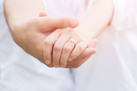 Woman and man holding hands shake, Happy couple love. concept couple lover valentine day. show ring weddingの写真素材