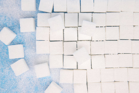 top view sugar cubes. White sugar on turquoise blue background. copy space. soft focus.の写真素材