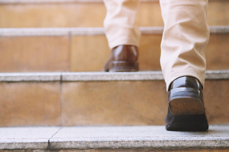 modern businessman working close-up legs walking up the stairs in modern city. in rush hour to work in office a hurry. During the first morning of work. stairwayの写真素材