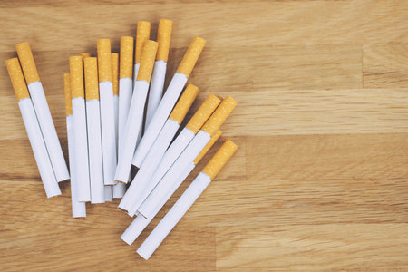 image of several commercially made cigarettes. pile cigarette on wooden. or Non smoking campaign concept, tobaccoの写真素材