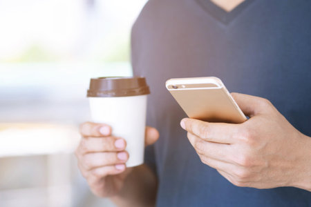 Travel blogger young man using route application using mobile smart phone reading to find the needed...