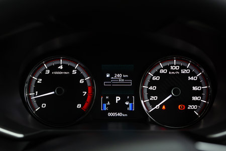 close up modern mileage car dashboard instrument panel interior with warning lights, seat belts and...