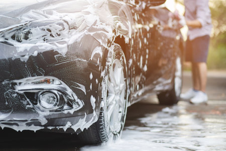 Outdoor car wash with active foam soap. commercial cleaning washing service concept.の写真素材