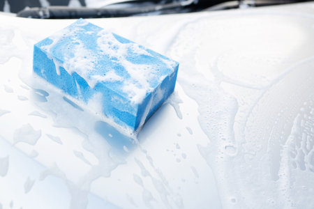 people man worker holding hand blue sponge for washing car. Concept car wash clean. soft focus.の写真素材