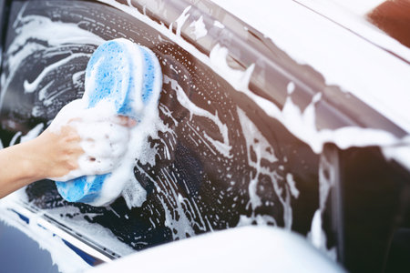 people man worker holding hand blue sponge for washing car. Concept car wash clean. soft focus.の写真素材