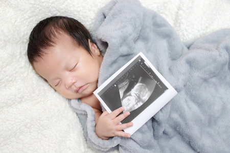 The baby is sleeping with the motherの写真素材