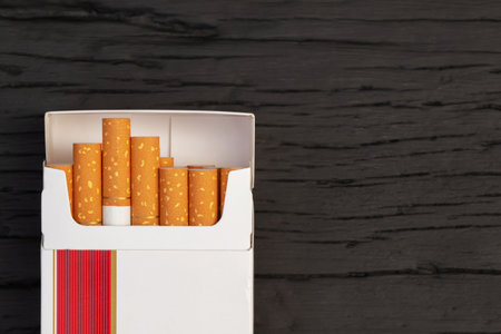 peel it off Cigarette pack prepare smoking a cigarette on the wooden. Packing line up. photo filters Natural light. soft focus. Leave space to write a description of the message.の写真素材