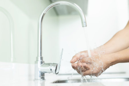 Men are washing their hands every time before eating to prevent germs, viruses, covid-19 and bacteria.の写真素材
