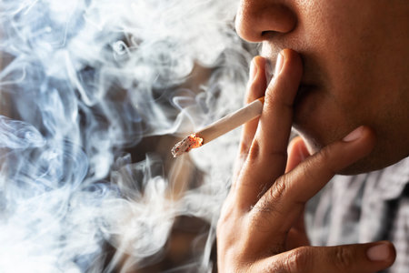 A man who is smoking Smelly throughout the roomの写真素材