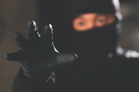 Burglar With Crowbar And Flashlight Looking Into A Houseの写真素材