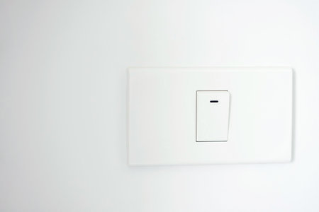 Turn off the light, close up man hand is closing the power switch. Save energy, reduce global warming.の写真素材