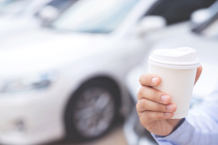 A man drinking coffee before drivingの写真素材