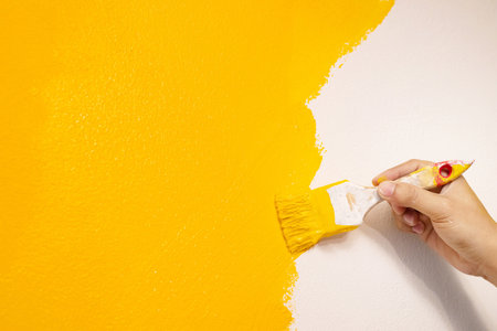 The mechanic is painting yellow on the wall.の写真素材