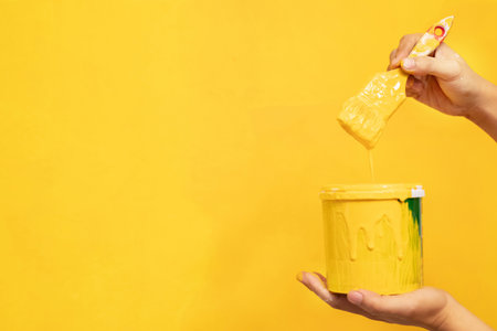 The mechanic is painting yellow on the wall.の写真素材