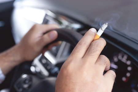 A man who smokes in the carの写真素材