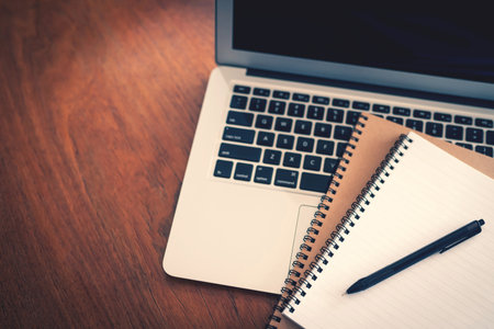 Working at home. Close-up image of young man working on laptop whileの写真素材