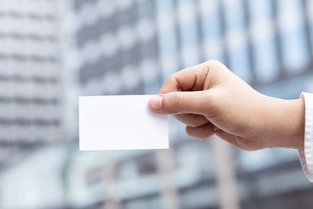 Business men holding business cards for customersの写真素材