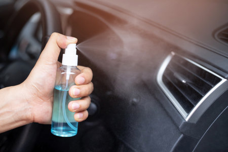 Spray cleaning car to protect against Corona virusの写真素材
