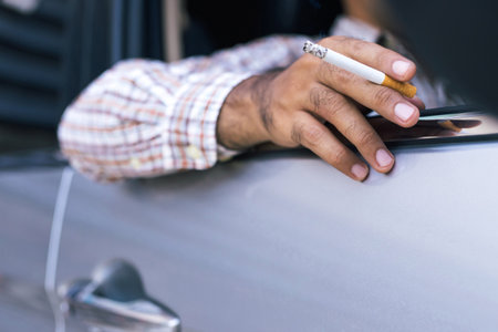 A man is smoking in the car