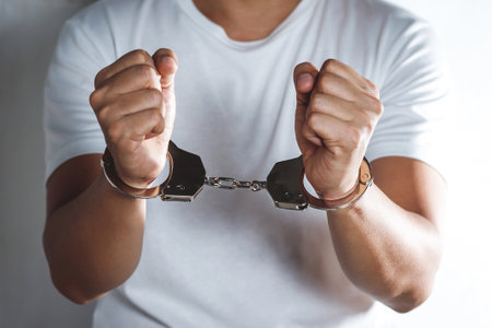 Handcuffed prisoner in jail