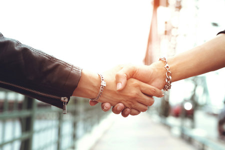 Teenagers shake hands for friendship