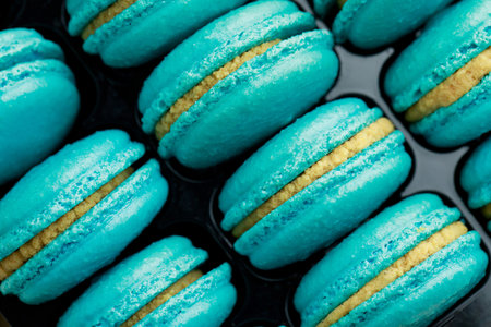 Sweet blue French macarons are in the bakery.