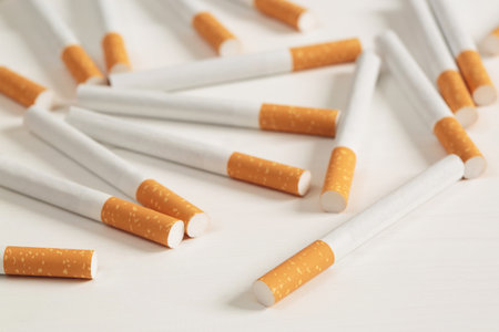 image of several commercially made pile cigarette on white  background. or Non smoking campaign concept, tobacco pattern top view.の写真素材