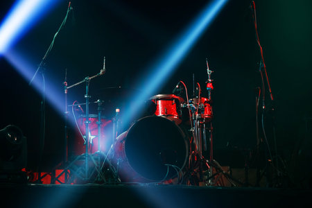 Red drum set ready for concert on stageの写真素材