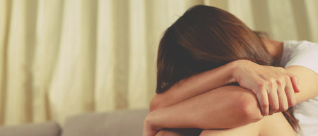 Woman sits stressed, depressed, breaks up with her boyfriend.の写真素材