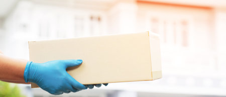 Delivery workers to customers at home from online shopping.の写真素材